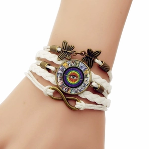 Detail of multi-layer woven bracelet with butterfly charm and infinity symbol on wrist