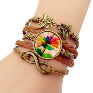 Detail of multi-layer leather bracelet with bronze butterfly and colorful glass charm