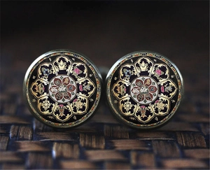 Close-up of bronze mandala cufflinks featuring sacred Tibetan Buddhist patterns