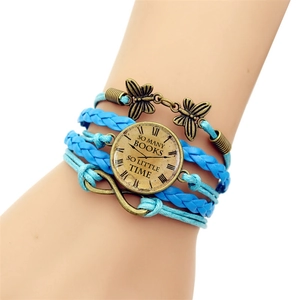 Detail view of light blue multi-layer woven bracelet with infinity and butterfly charms