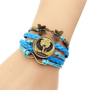 Detail of multi-layer woven leather bracelet with Egyptian goddess Isis pendant and charms