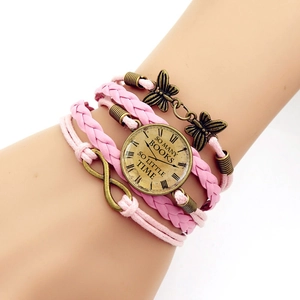 Detail of pink multi-layer woven bracelet with bronze butterfly and infinity charms