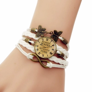 Close-up of vintage multi-layer braided bracelet with infinity sign and butterfly detail