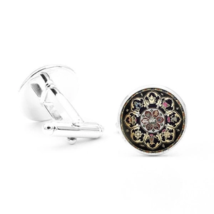 Detailed macro view of silver-plated cufflinks with intricate black mandala patterns