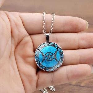 Detailed macro view of the Triple Moon Goddess pendant with mystical blue star pattern