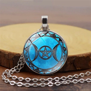 Triple Moon Goddess necklace with blue pentagram glass dome pendant on wooden base