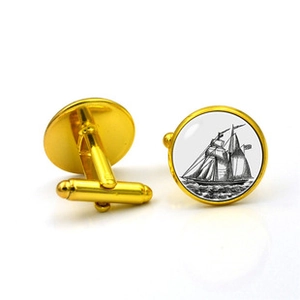 Detail of gold nautical cufflinks featuring vintage sailing ship artwork and bullet back