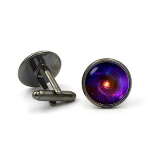 Detailed macro view of men's cufflinks featuring purple galaxy nebula in glass cabochon