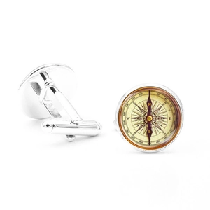 Detailed macro view of vintage compass cufflinks showing the silver frame and T-bar back