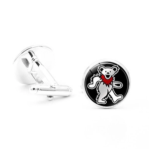 Detailed macro view of silver round cufflinks featuring a colorful dancing bear pattern