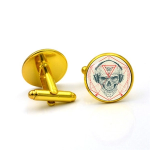 Detailed view of gold skull cufflinks with headphones and geometric art background