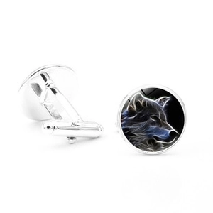 Detail view of silver wolf cufflinks with blue luminous pattern for men's suits