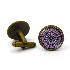 Vintage bronze cufflinks with Notre Dame rose window pattern under glass dome