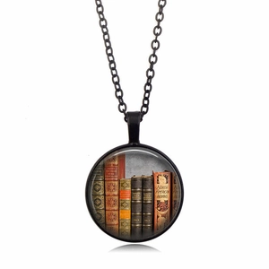 Detailed close-up of a circular vintage book spine pendant with a black alloy chain link