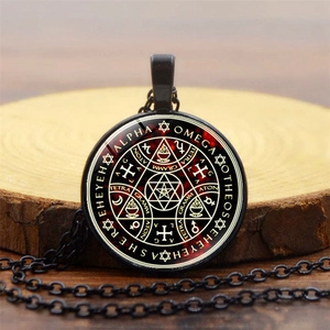 Detail shot of a mystical Tree of Life glass pendant on a rustic wooden surface
