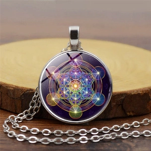 Macro view of Metatron's Cube sacred geometry pendant with glowing neon stars