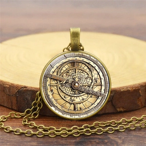 Detailed close-up of a bronze vintage compass pendant featuring astronomical chart patterns