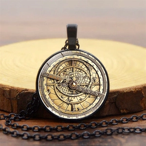 Detailed macro view of vintage bronze compass pendant on natural wood slice with constellation motifs