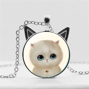 Macro view of silver cat ear pendant with blue-eyed cartoon cat and glass dome