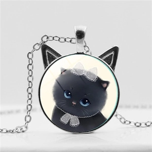 Macro shot of silver cat ear pendant with blue-eyed black kitten illustration and chain