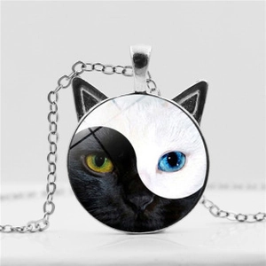 Detailed view of cat-shaped pendant with Yin Yang motif and heterochromia eyes