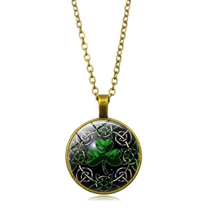 Detailed macro view of bronze pendant with green shamrock and Celtic knot pattern