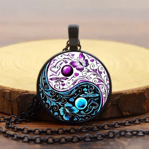Close-up of Yin Yang Tai Chi butterfly glass pendant with vintage black alloy chain