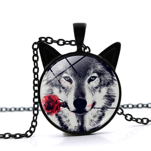 Detail view of a cat-ear pendant featuring a wolf and red rose under round glass