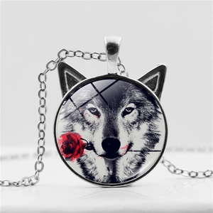 Detailed macro view of a wolf head and rose art glass pendant with silver ear accents