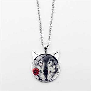 Detailed macro view of silver wolf totem pendant with red rose and cat ear frame necklace