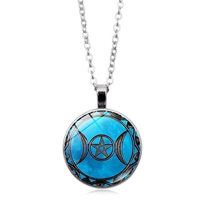 Macro detail of the Triple Moon Goddess pendant with a starry glass dome and silver base
