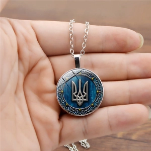 Ukraine trident pendant necklace with blue wood texture background on a silver chain