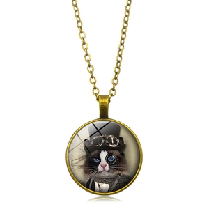 Macro detail of steampunk cat pendant with bronze chain and vintage glass cabochon