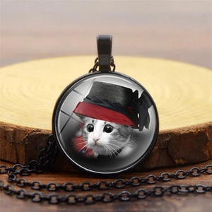 Close-up of vintage cat pendant necklace with glass dome and black alloy chain link