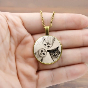Vintage bronze necklace with a glass dome pendant featuring three owls sketch illustration