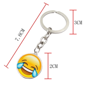 Metal laughing emoji glass keychain with round pendant measuring 7.8cm in length