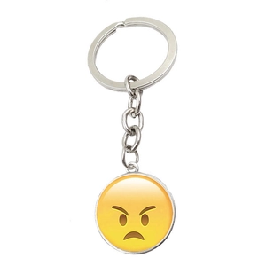 Detail shot of a silver metal keychain with an angry emoji glass cabochon pendant