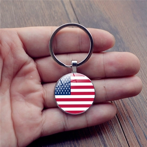 Handheld silver metal keychain featuring a round USA American flag glass cabochon pendant