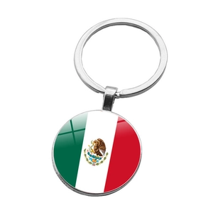 Detailed close-up of the round metal keychain featuring the Mexican flag design