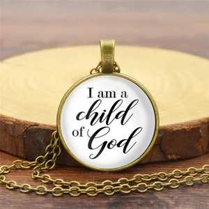Vintage bronze child of God pendant necklace with a white circular glass charm