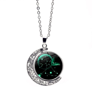 Detail of rotating crescent moon pendant with glowing Sagittarius zodiac glass cabochon
