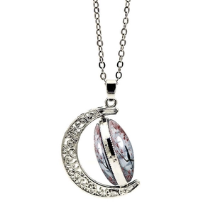 Detailed view of silver crescent moon necklace with a rotating floral black cat charm