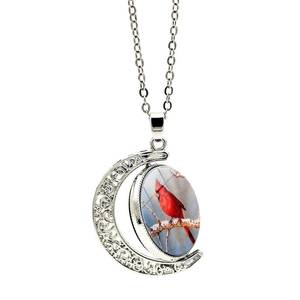Silver crescent moon necklace featuring a rotating red cardinal bird glass pendant