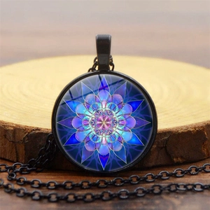 Detailed view of mandala glass pendant necklace on a wooden rustic background