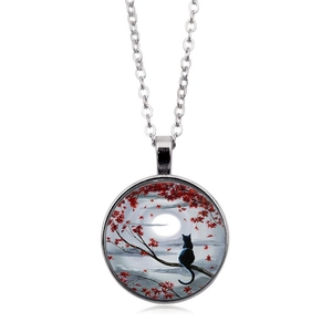 Vintage necklace with black cat silhouette on a full moon and red maple leaf glass pendant
