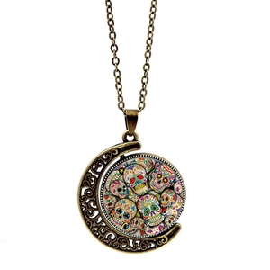 Vintage bronze sugar skull pendant necklace with crescent moon frame on white background