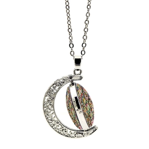 Detail of a hollow crescent moon pendant featuring a rotating sugar skull glass gem
