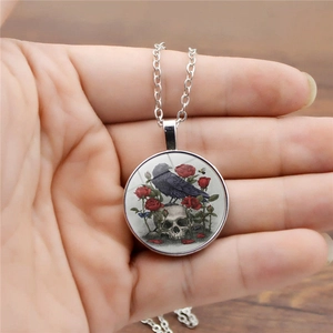 Vintage Gothic raven and skull necklace with red roses on a silver chain pendant