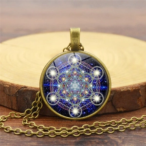 Sacred geometry mandala necklace featuring bronze base on natural wood surface macro