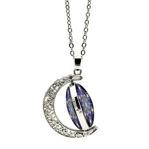 Macro shot of double-sided rotating moon pendant with mandala glass gem on silver chain
